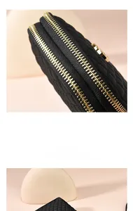 Detail of black quilted oxford fabric bag with premium golden double zippers and soft texture