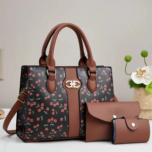 Three-piece black handbag set with red cherry prints and brown leather handles
