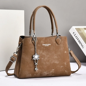 Classic dark brown women's handbag with vintage texture and elegant floral pendant