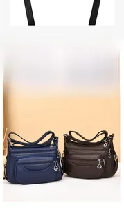 Detail view of large capacity PU leather shoulder bags with multi-zipper pockets