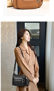 Detail of soft lychee texture leather shoulder bag with triple U-shaped zipper pockets
