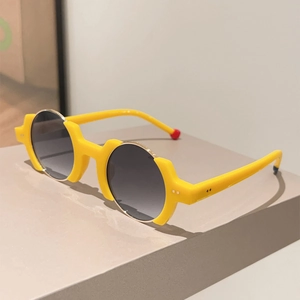 Detail of yellow round frame sunglasses with blue and red accent tips on temples
