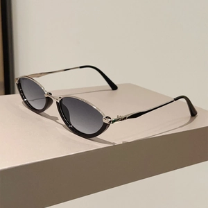 Detail view of cat eye sunglasses with black acetate and silver metal frame contrast