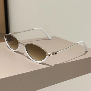 Detail of trendy white semi-rimless cat-eye sunglasses with gold metal temples