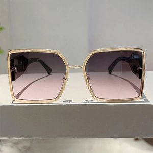 Detail of square gold metal frame sunglasses with purple gradient lenses and tortoise temples