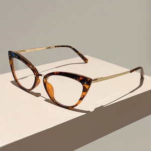 Détail de lunettes œil-de-chat vintage avec monture en écaille et branches fines dorées