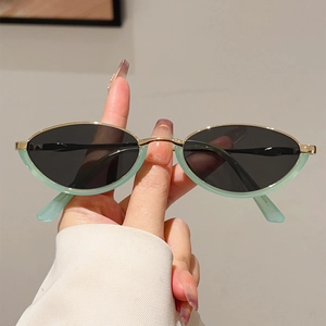 Retro mint green oval sunglasses with gold metal bridge and dark UV lenses for women
