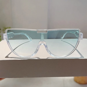 Detail of pilot sunglasses with light blue lenses and clear acrylic flat top frame