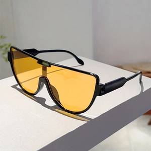 Detail view of large-frame pilot sunglasses with black frame and orange lenses