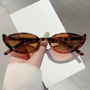 Close-up of retro cat-eye sunglasses featuring a classic dark brown tortoiseshell frame