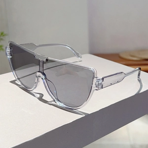 Close-up of oversized shield sunglasses with transparent frames and light grey lenses