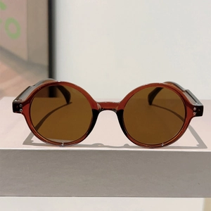 Close-up of vintage round amber frames with silver rivets and dark brown lenses