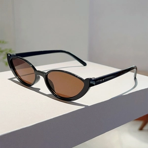Close-up of retro black cat-eye sunglasses on geometric white display stands