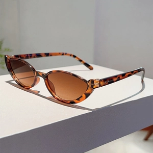 Detailed view of cat eye sunglasses featuring tortoise shell pattern and silver rivets