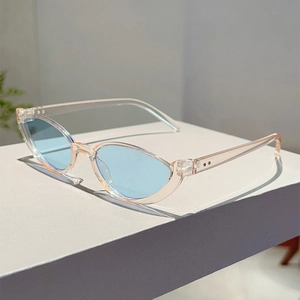 Side view of cat-eye sunglasses with light blue lenses and transparent champagne frames