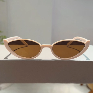 Detailed front view of retro cat-eye sunglasses with apricot frames and brown lenses