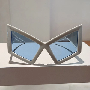 Macro detail of futuristic butterfly frame sunglasses with blue translucent lenses