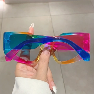 Close-up of stylish rectangle sunglasses featuring rainbow gradient transparent frames