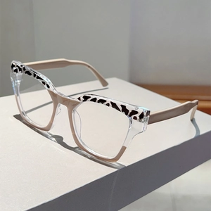 Close-up of cat-eye glasses with leopard print upper frame on a white display block