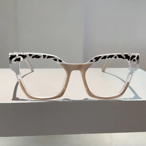 Close-up of leopard print accents on transparent cat-eye optical eyeglass frames