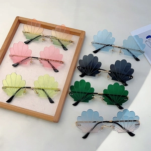 Frameless shell shaped sunglasses with gold metal temples and multiple gradient lenses