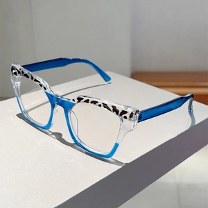 Detail of square cat-eye glasses frame featuring blue color-blocking and spotted patterns