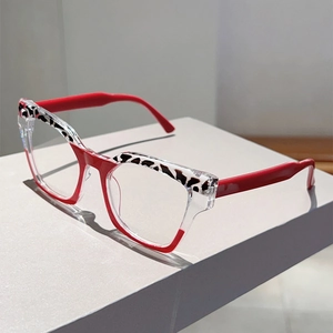 Detail of stylish cat-eye glasses with red and white color blocking and leopard print