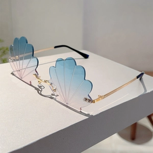 Detailed view of rimless shell-shaped sunglasses with blue and pink gradient lenses