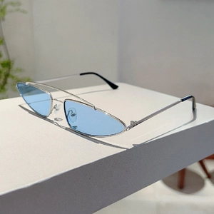 Detailed close-up of slim silver metal frames and light blue lenses on retro cat eye sunglasses