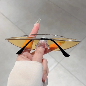 Detail of silver double-bridge metal frames and yellow lenses on triangle sunglasses