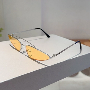 Detail view of silver metal frames with orange lenses and soft silicone nose pads