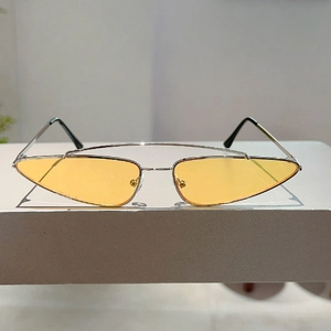 Detail showing silver metal double bridge frames and yellow transparent lenses on sunglasses