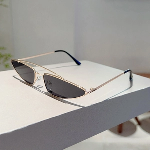 Detail view of small triangle sunglasses with double-bridge golden metal frame and black lenses