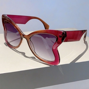 Detail view of butterfly frame sunglasses with red-purple gradient resin and leopard pattern