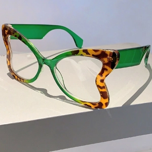 Macro view of butterfly glasses frame with leopard print and green transparent temples
