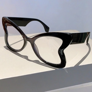 Detail view of bold black butterfly cat-eye frames with wave-shaped lower edges