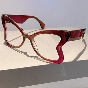Detail of burgundy gradient butterfly frames with unique wavy edges on a white display