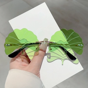 Frameless ginkgo leaf sunglasses with green transparent lenses and gold metal bridge