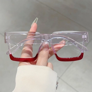 Close-up of square glasses frame with purple and red gradient and silver metal hinge
