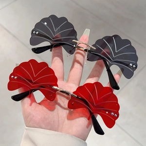 Unique rimless ginkgo leaf sunglasses with metallic rivets and sleek temples