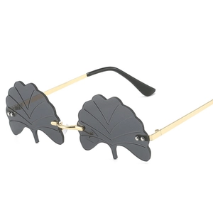 Frameless ginkgo leaf sunglasses with grey tinted lenses and gold metal temples