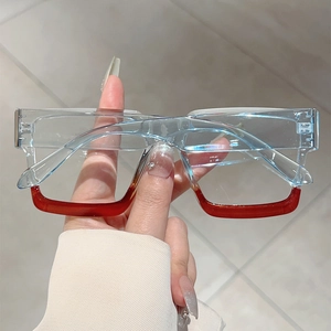Detail of color-block square glasses frame in transparent blue and burgundy finish