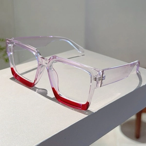 Detail of square glasses featuring translucent purple frames with bold red contrast color