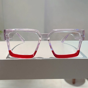 Detail of square glasses frame with purple and red two-tone color blocking design