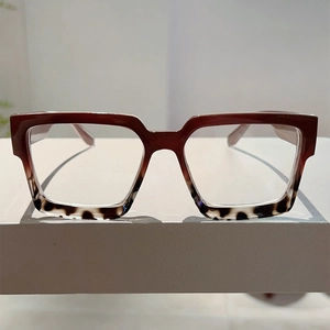 Detailed front view of square frame glasses with gradient red and tortoise pattern