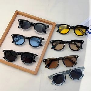 Retro round frame sunglasses set in multiple colors with metal rivet accents