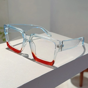 Detail shot of blue and orange square frame glasses with visible silver metal hinges