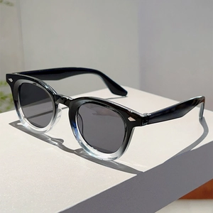 Detailed close-up of retro sunglasses with silver arrow rivets and gradient frames