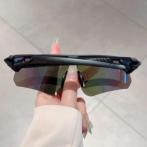 Detail of polarized cycling sunglasses featuring colorful iridescent lens and side vents