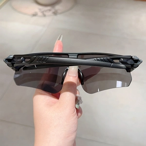 Close-up of black cycling sunglasses with grey wraparound lenses and anti-slip frame design